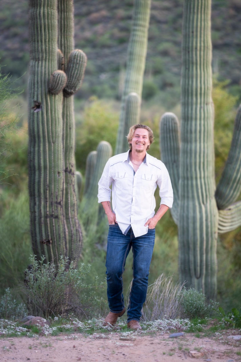 Tucker Barefoot among saguaros